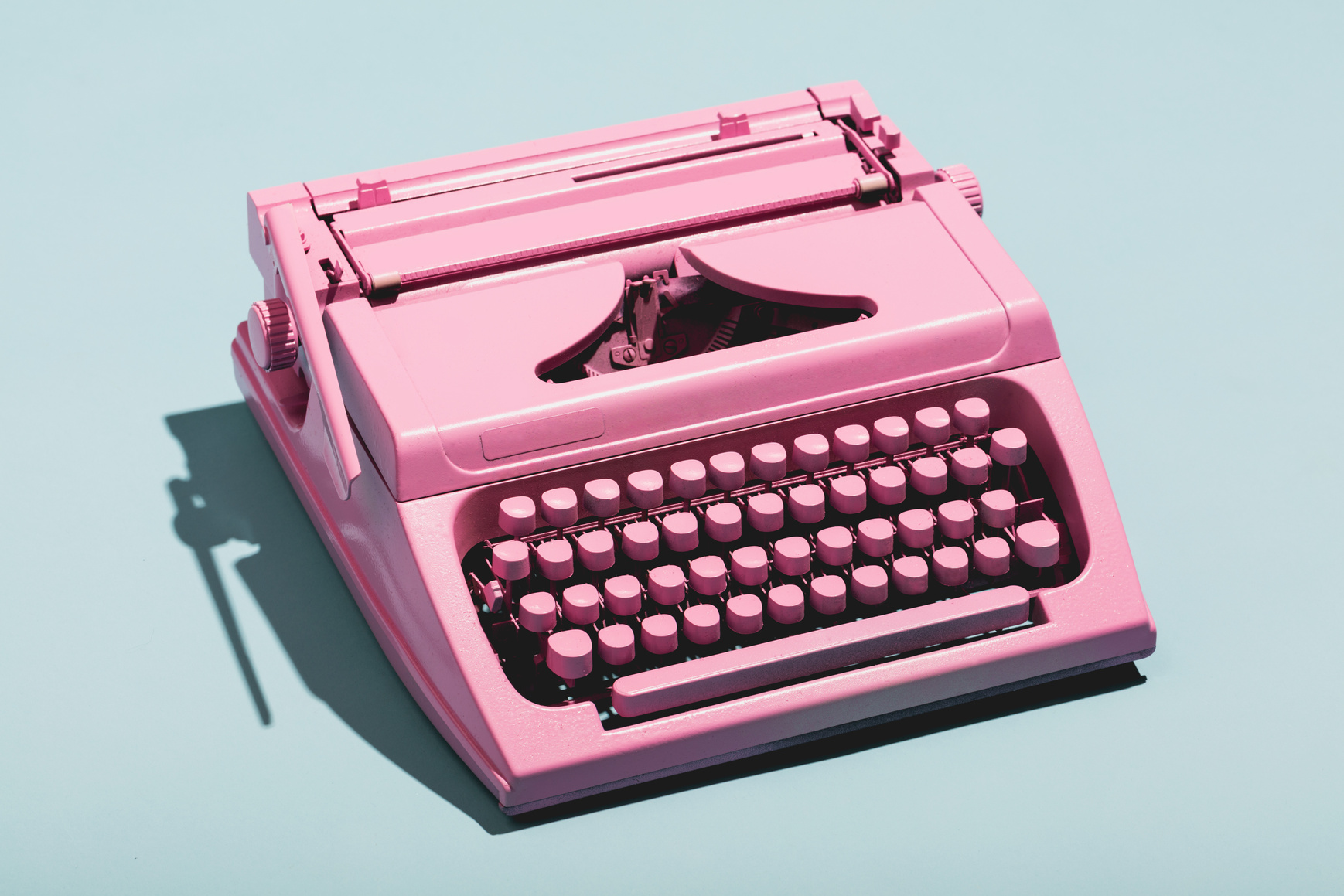 Pink Typewriter on a Blue Pastel Background